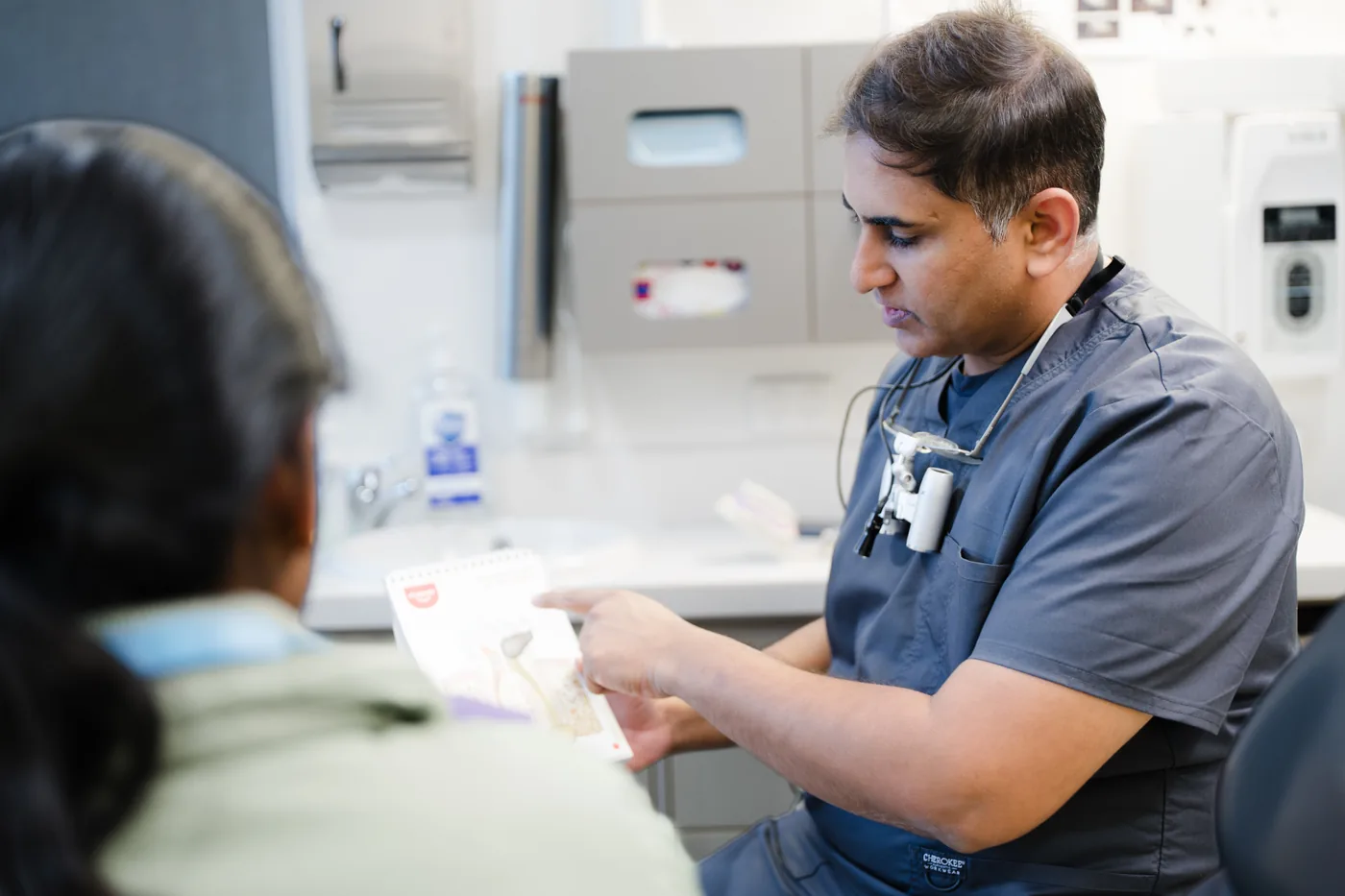 Dentist discussing nervous-patient support